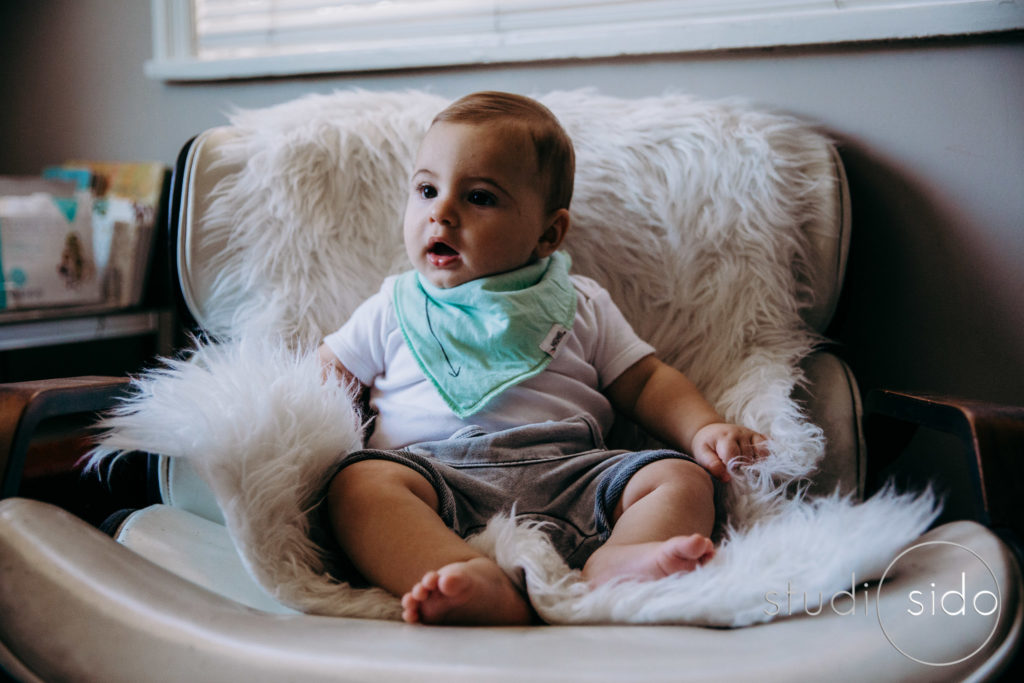 A baby boy sits in a vintage chair in Silver Lake, Los Angeles, CA