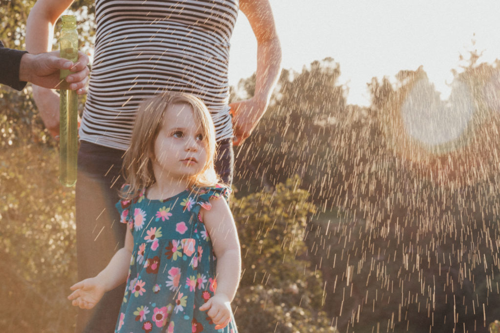 A bubble pops down on little girl and her mom